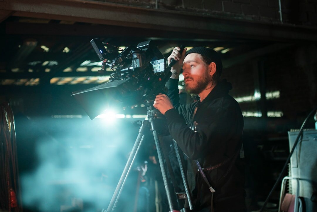 Camera operator filming with a professional broadcast camera during a live event